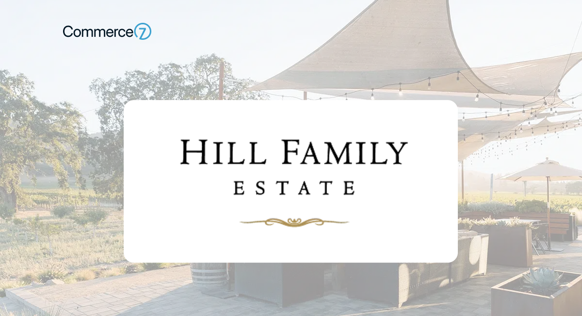 Outdoor wine tasting area at Hill Family Estate with shaded seating and scenic vineyard views.